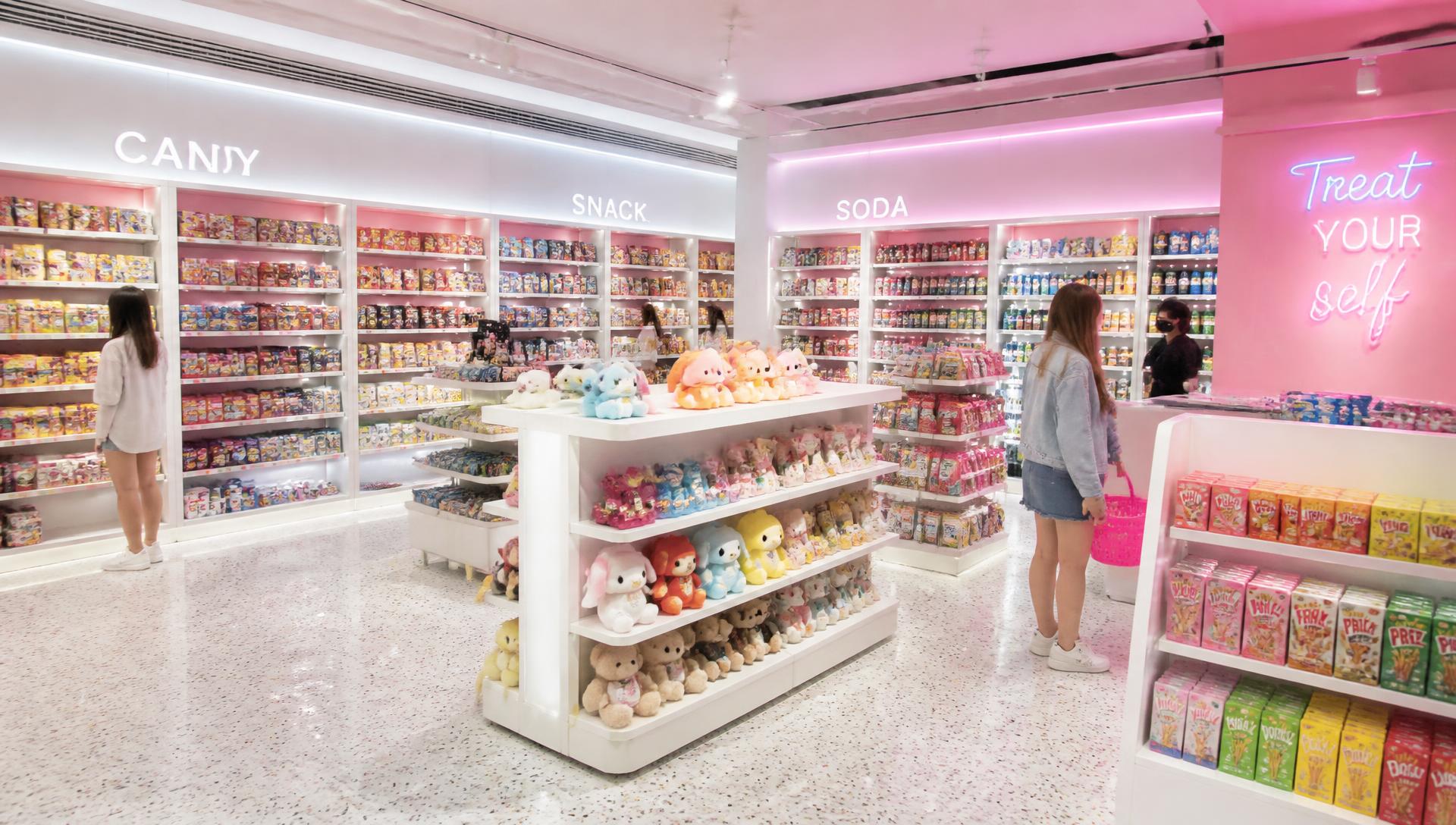 Inside a Trendy Candy store, with walls of colorful international snacks and plush toys